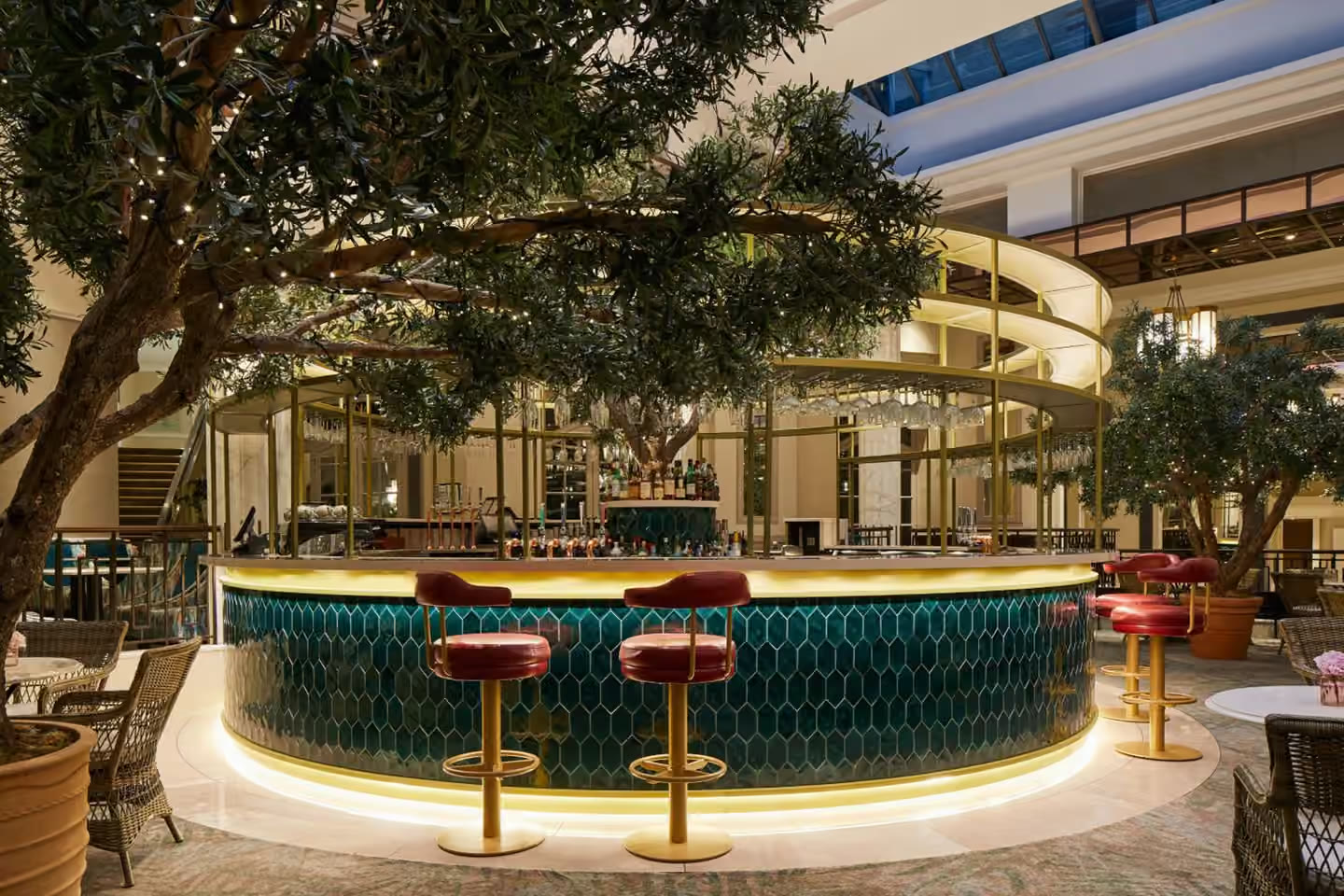 The Midland hotel bar beneath mature indoor trees